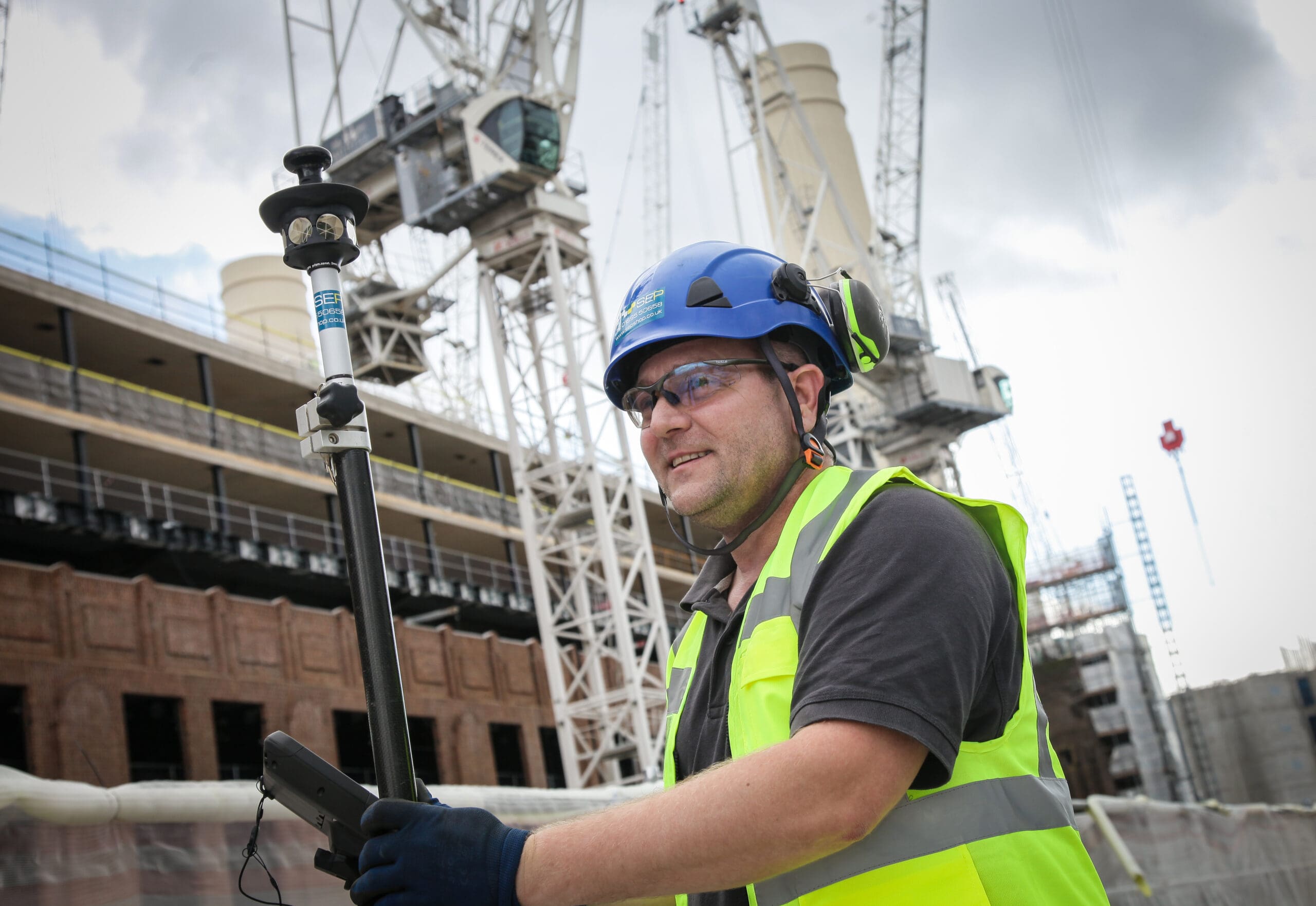 Setting out engineer working on site layout in Hillingdon